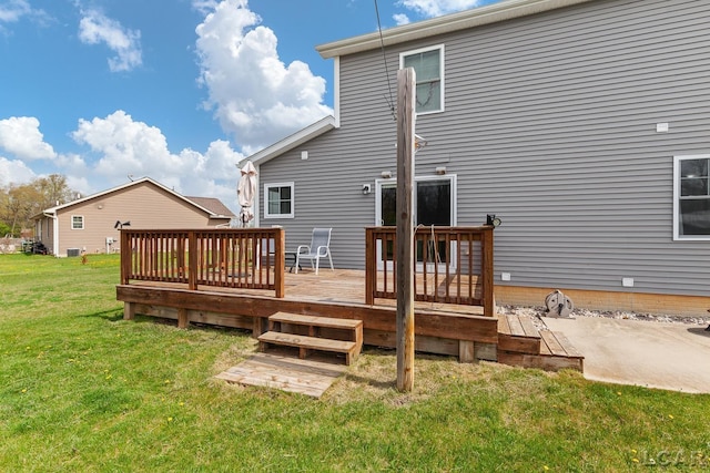 rear view of property featuring a yard and a wooden deck