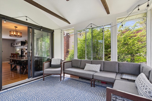 sunroom / solarium with beamed ceiling and an outdoor living space