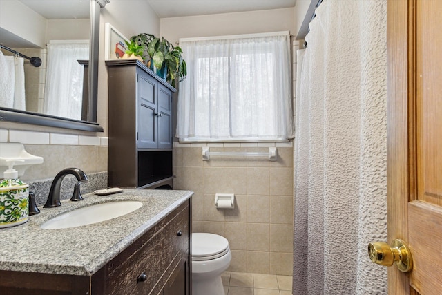 bathroom featuring a shower with curtain, tile walls, toilet, tile patterned floors, and vanity