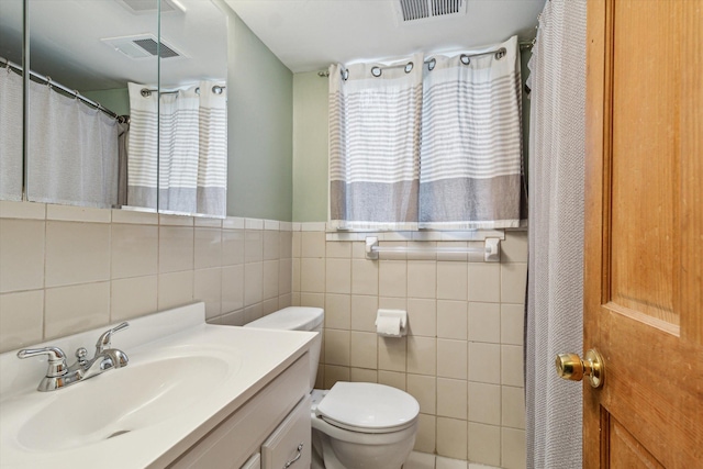 bathroom featuring toilet, a wealth of natural light, and visible vents