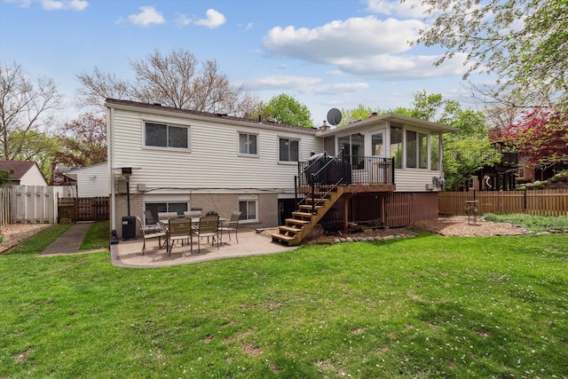 back of property featuring a patio, a sunroom, a lawn, stairway, and a fenced backyard