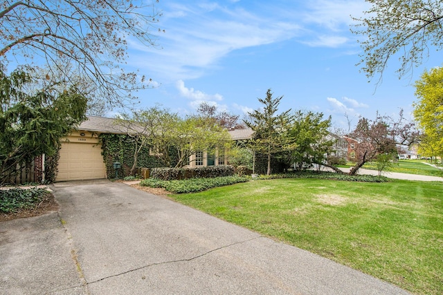 obstructed view of property featuring driveway, a front yard, and a garage