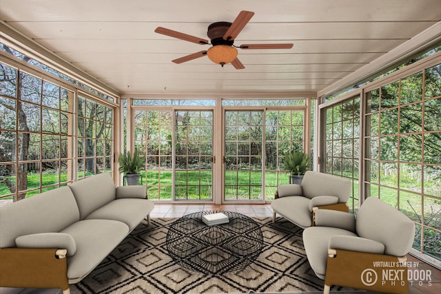 sunroom / solarium featuring a ceiling fan, outdoor lounge area, and a wealth of natural light