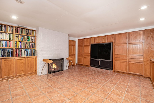 unfurnished living room featuring recessed lighting and a large fireplace