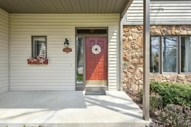 entrance to property featuring stone siding
