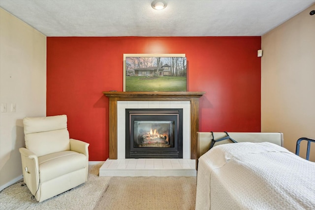 living area featuring baseboards, carpet, and a fireplace