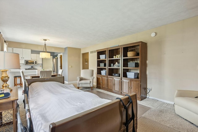 bedroom with baseboards and visible vents