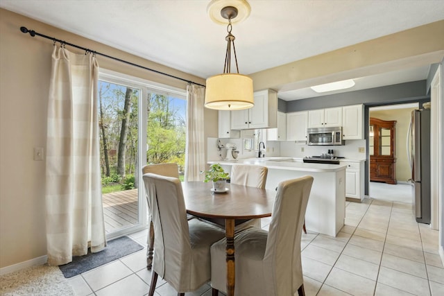 dining space with light tile patterned floors and baseboards