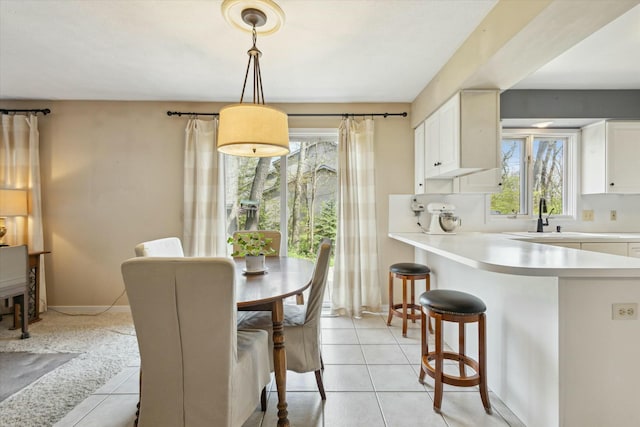 dining area featuring plenty of natural light and light tile patterned flooring