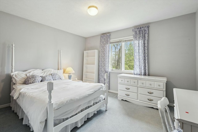 bedroom with baseboards and light colored carpet