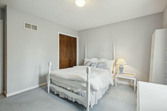bedroom with visible vents, baseboards, a closet, and light carpet