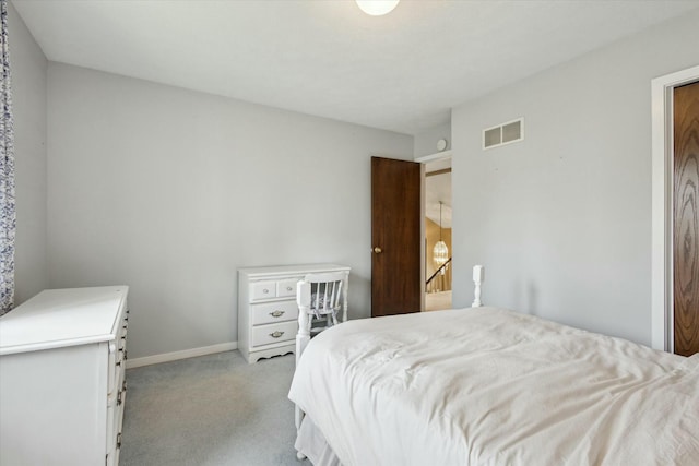 bedroom with baseboards, visible vents, and light carpet