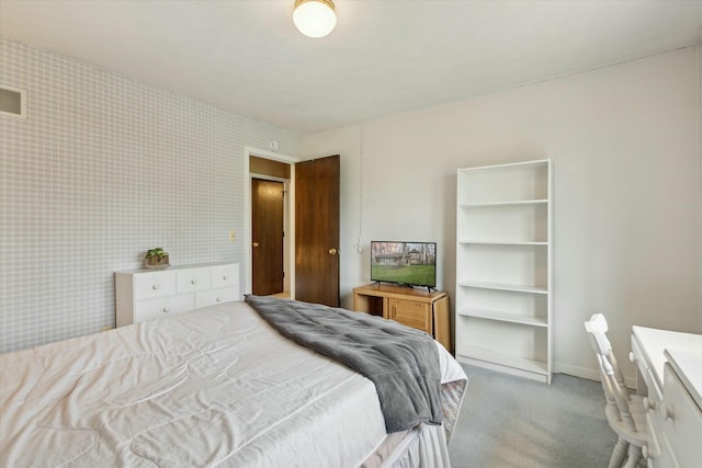 carpeted bedroom featuring baseboards, visible vents, and wallpapered walls