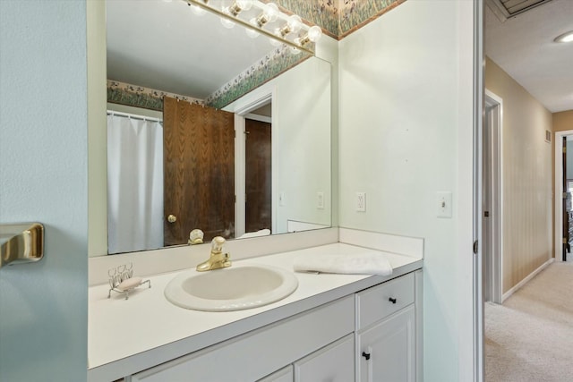 full bathroom featuring baseboards and vanity