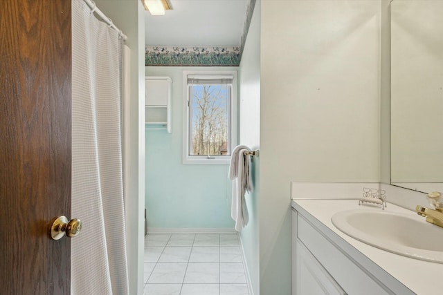 full bath featuring baseboards and vanity