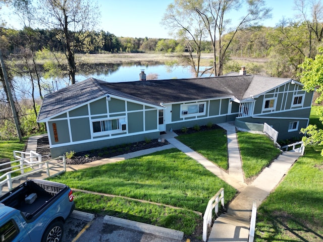 1298 E Highland Rd, Highland, MI 48356 - view of front of home with a water view, a front yard, a shingled roof, and uncovered parking