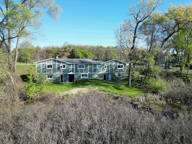 1298 E Highland Rd, Highland, MI 48356 - back of property with a lawn and a chimney