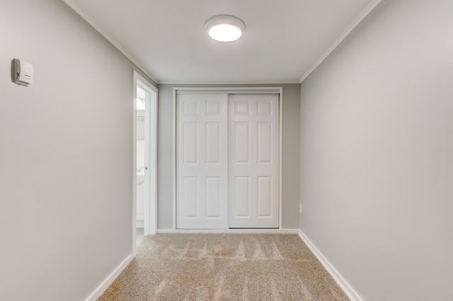 1298 E Highland Rd, Highland, MI 48356 - unfurnished bedroom featuring baseboards, carpet, a closet, and crown molding