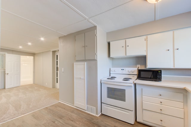 1298 E Highland Rd, Highland, MI 48356 - kitchen featuring electric range, black microwave, light wood-type flooring, light countertops, and white cabinetry