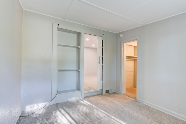 1298 E Highland Rd, Highland, MI 48356 - unfurnished bedroom featuring carpet, a closet, crown molding, and baseboards