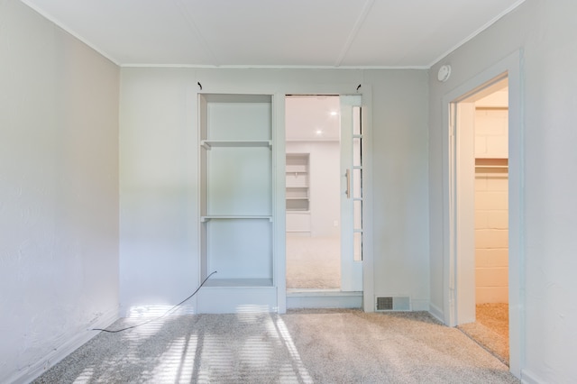 1298 E Highland Rd, Highland, MI 48356 - unfurnished bedroom featuring carpet, ornamental molding, and a closet