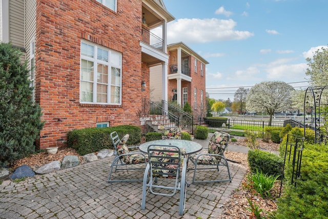 29044 Thistle Ln, Harrison Township, MI 48045 - view of patio featuring fence, a balcony, and outdoor dining space