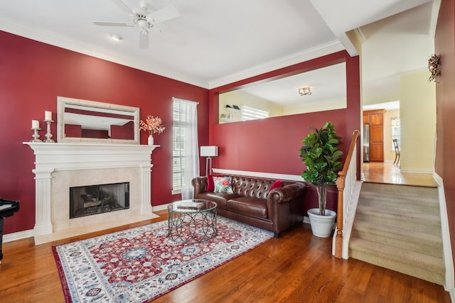 29044 Thistle Ln, Harrison Township, MI 48045 - living room with crown molding, wood finished floors, ceiling fan, stairway, and a premium fireplace