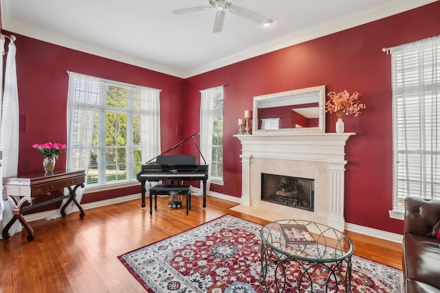29044 Thistle Ln, Harrison Township, MI 48045 - living area with crown molding, wood finished floors, a fireplace, baseboards, and a ceiling fan