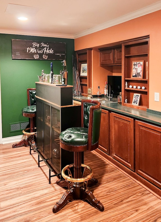 29044 Thistle Ln, Harrison Township, MI 48045 - bar featuring crown molding, a sink, light wood-style flooring, and visible vents