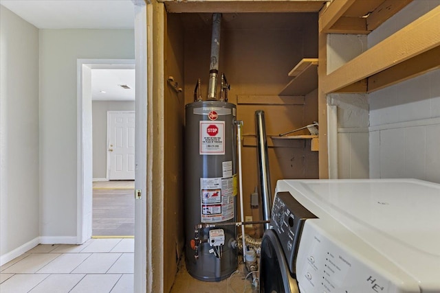 utility room featuring gas water heater and washer / clothes dryer