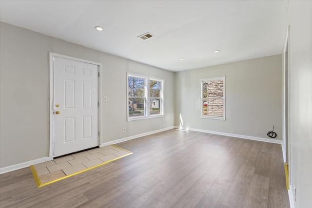 foyer featuring visible vents, recessed lighting, baseboards, and wood finished floors