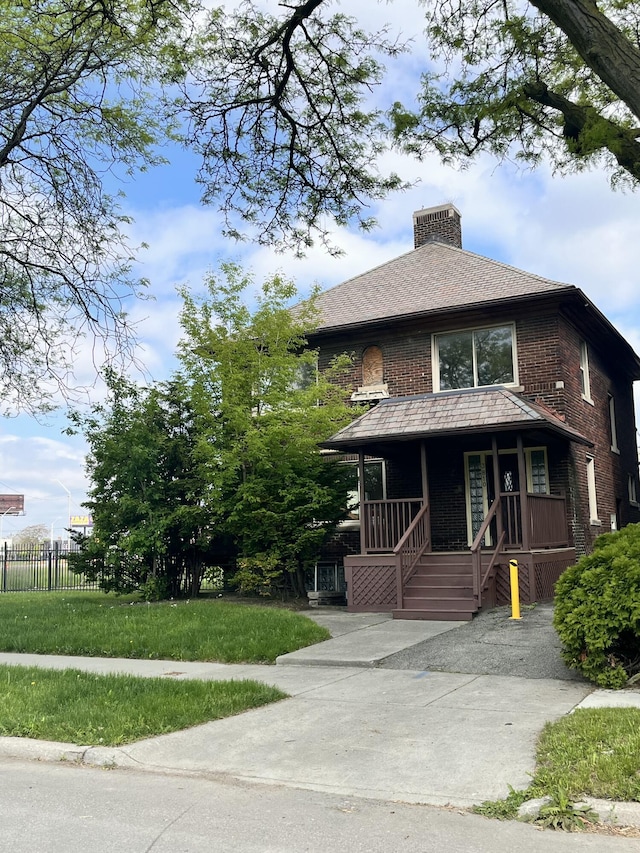 3810 Northwestern St, Detroit, MI 48206 - view of front facade featuring a porch, a chimney, and brick siding