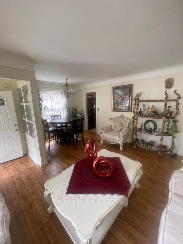living room featuring a chandelier and wood finished floors