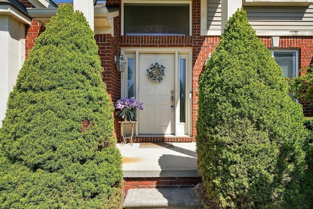 property entrance featuring brick siding