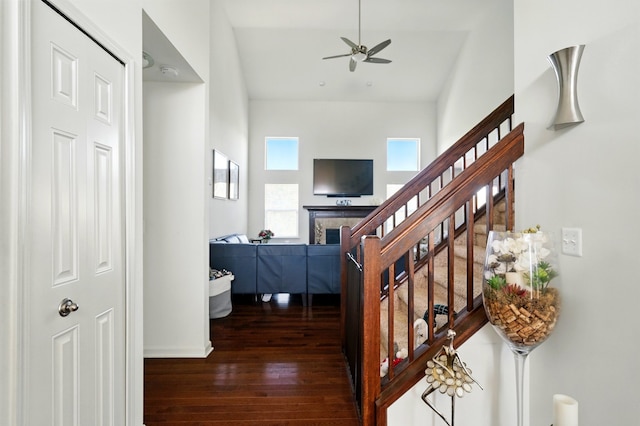 hallway with wood-type flooring, baseboards, and stairway