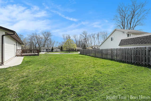 view of yard featuring fence and a wooden deck