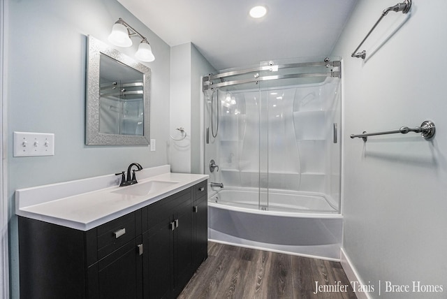 full bath with vanity, enclosed tub / shower combo, and wood finished floors