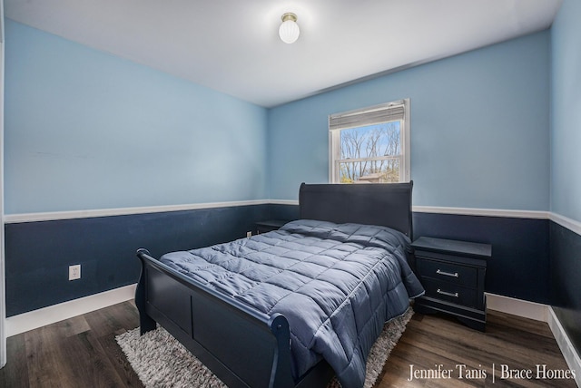 bedroom featuring baseboards and wood finished floors