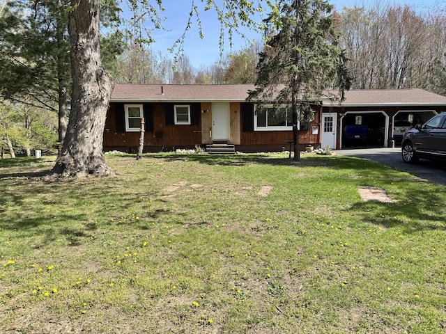 single story home with entry steps, an attached garage, a front yard, and aphalt driveway