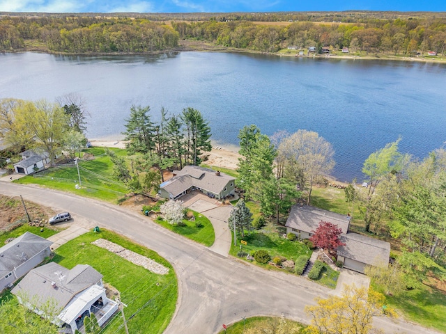drone / aerial view with a water view and a wooded view