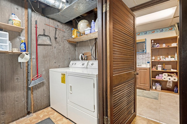 clothes washing area featuring washing machine and clothes dryer and laundry area