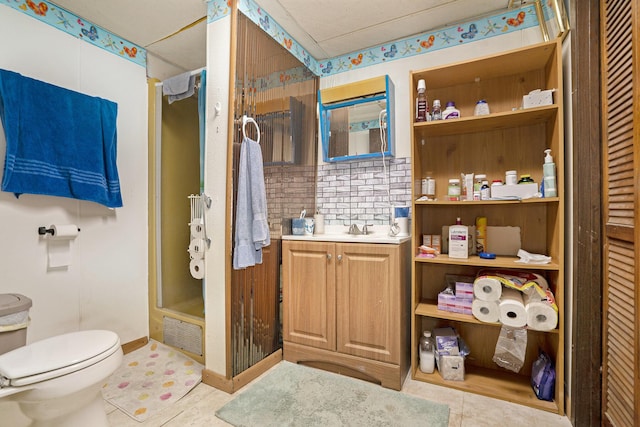 bathroom featuring vanity, toilet, a shower stall, backsplash, and visible vents