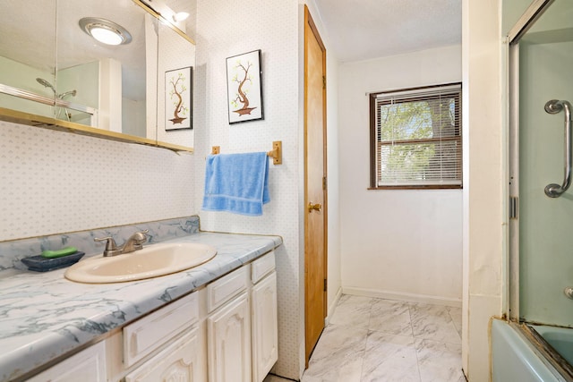 bathroom with vanity, enclosed tub / shower combo, marble finish floor, wallpapered walls, and baseboards