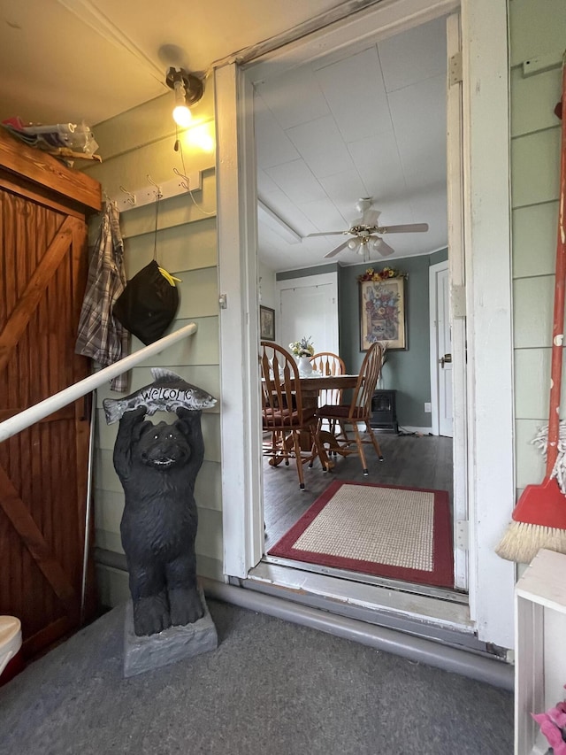 interior space with ceiling fan
