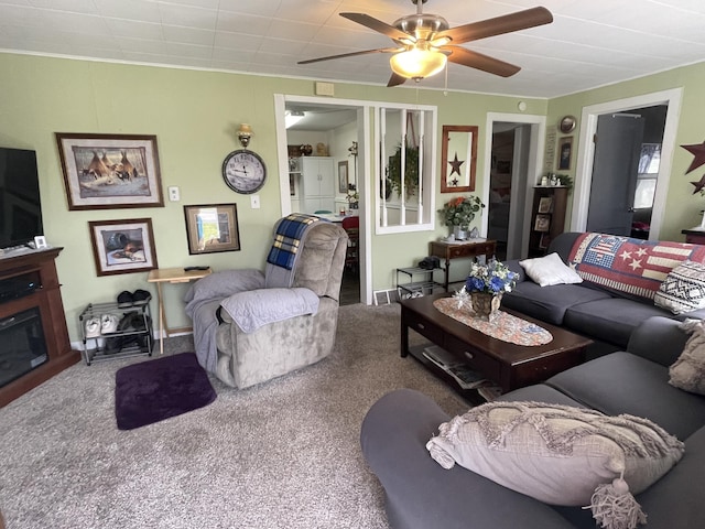 carpeted living room with ceiling fan