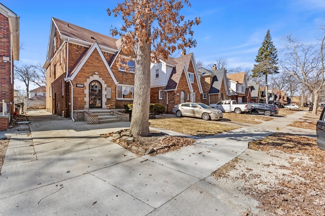 16509 Northlawn St, Detroit, MI 48221 - tudor-style house with a residential view, concrete driveway, and brick siding