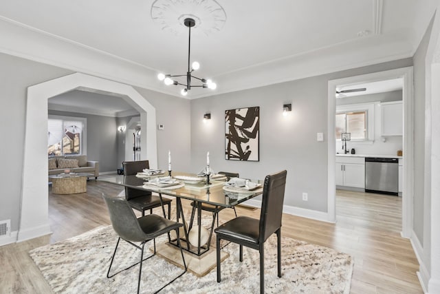 16509 Northlawn St, Detroit, MI 48221 - dining area featuring light wood-style floors, arched walkways, baseboards, and visible vents