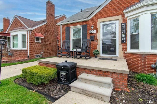 exterior space with a chimney and brick siding