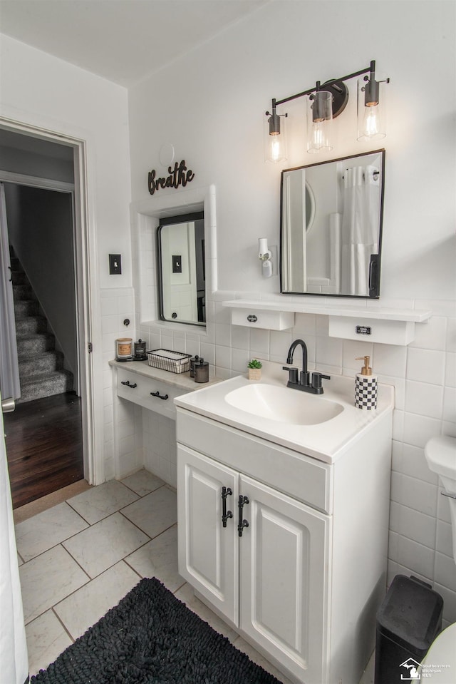 bathroom featuring tile walls and vanity