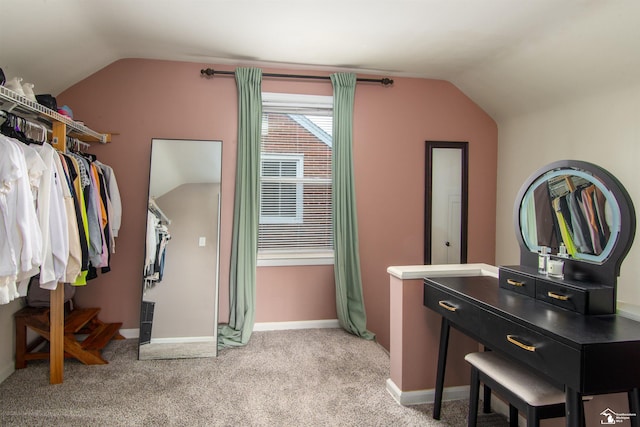 interior space featuring lofted ceiling and light carpet